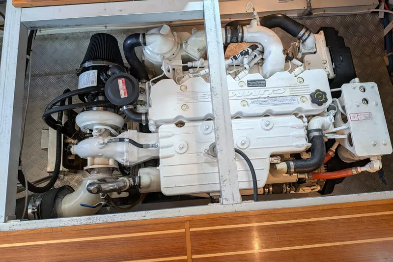 Slide: The Image of Engine compartment of a 2006 North Pacific 42 Pilothouse, featuring a Cummins marine engine. - 37