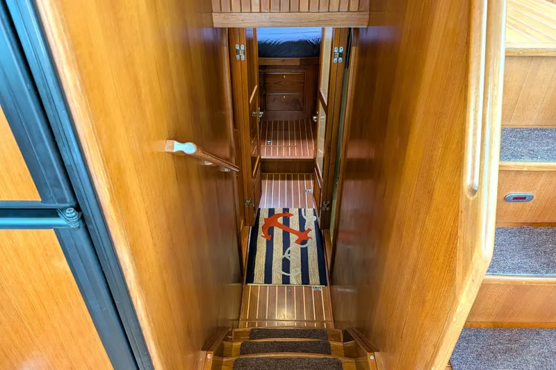 Slide: The Image of Interior view of 2006 North Pacific 42 Pilothouse with wooden stairs and nautical-themed rug. - 39