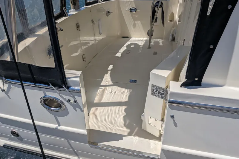 Slide: The Image of 2006 North Pacific 42 Pilothouse boat deck with open entry and chrome details. - 4