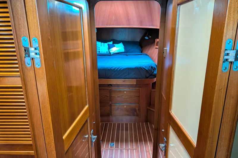 Slide: The Image of Cozy cabin interior of 2006 North Pacific 42 Pilothouse with wooden finish and bed. - 41