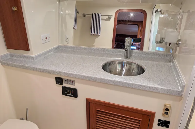 Slide: The Image of Bathroom sink area in a 2006 North Pacific 42 Pilothouse yacht, featuring modern fixtures. - 45