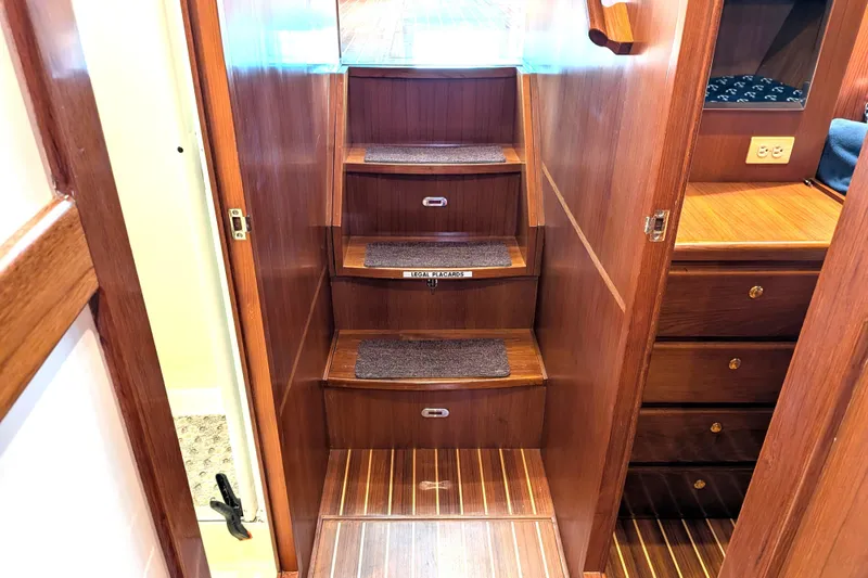 Slide: The Image of Staircase inside 2006 North Pacific 42 Pilothouse, featuring wooden steps and cozy interior design. - 47