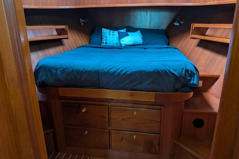 Slide: The Image of Cozy cabin interior of 2006 North Pacific 42 Pilothouse with wooden finish and blue bedding. - 49