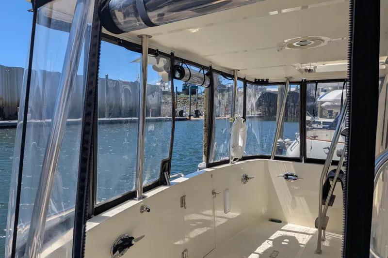 Slide: The Image of Interior view of 2006 North Pacific 42 Pilothouse boat with clear windows and water backdrop. - 5