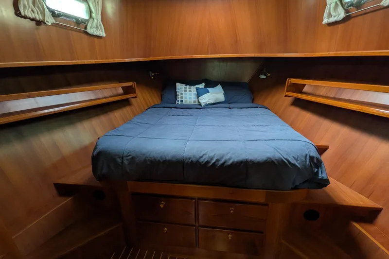 Slide: The Image of Cozy cabin interior of 2006 North Pacific 42 Pilothouse with wooden finish and comfortable bedding. - 51