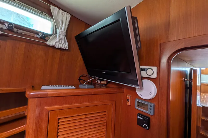 Slide: The Image of Interior of 2006 North Pacific 42 Pilothouse with mounted TV and control panels. - 52