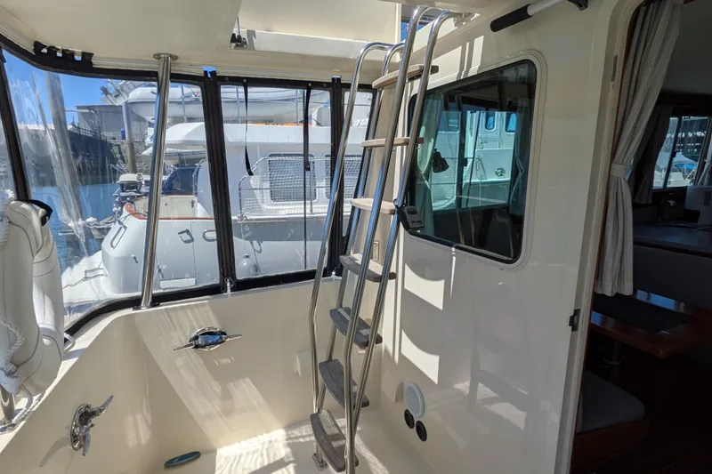 Slide: The Image of Interior view of a 2006 North Pacific 42 Pilothouse yacht with ladder and window. - 6