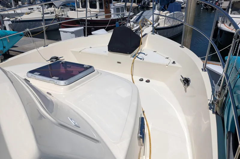Slide: The Image of 2006 North Pacific 42 Pilothouse boat deck, featuring sleek design and marina setting. - 9