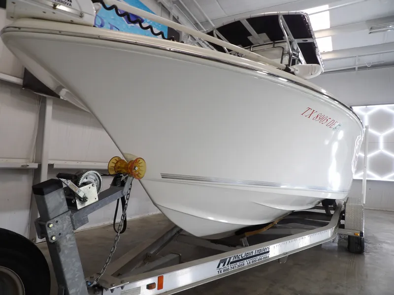 Slide: The Image of 2016 Key West 219 FS boat on trailer in warehouse. - 11