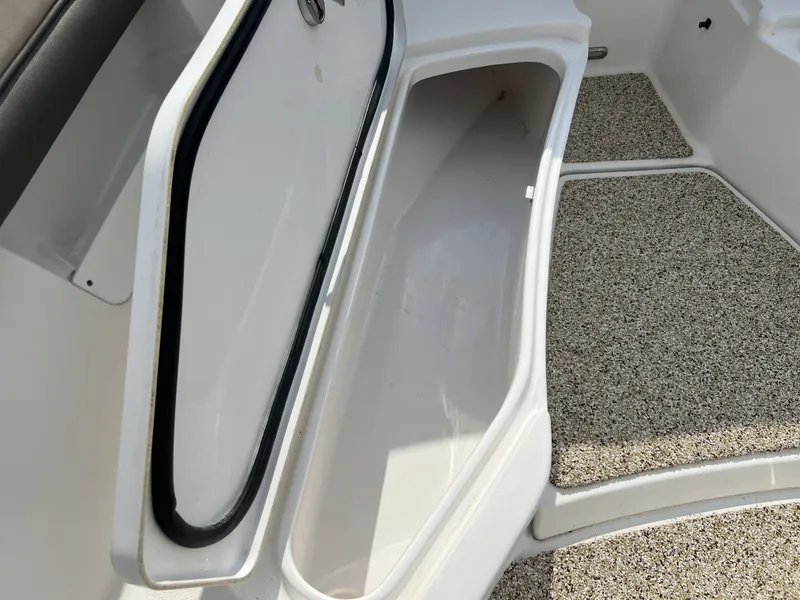 Slide: The Image of Open storage compartment on a 2021 Tidewater 292 CC Adventure boat. - 18