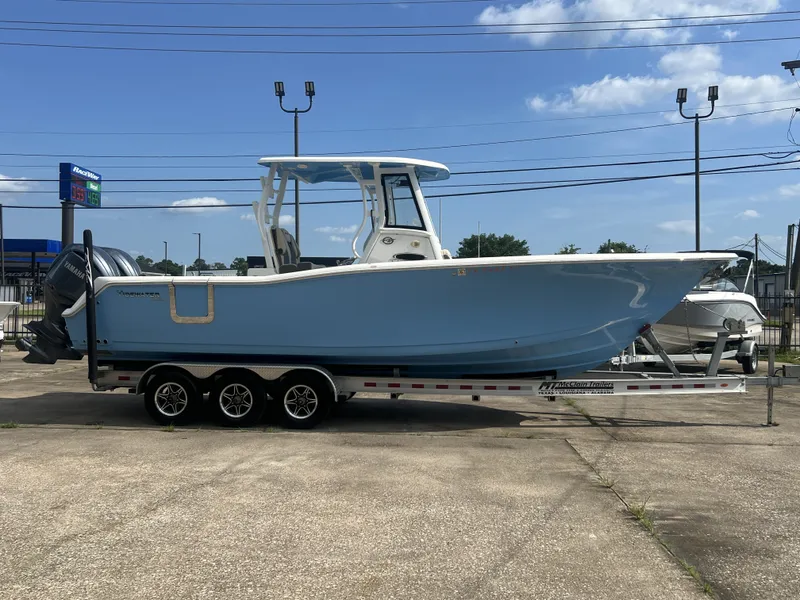 Slide: The Image of 2021 Tidewater 292 CC Adventure boat on trailer, side view. - 7
