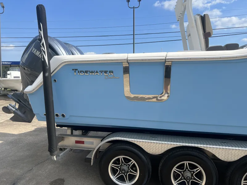 Slide: The Image of 2021 Tidewater 292 CC Adventure boat on trailer, blue color. - 8