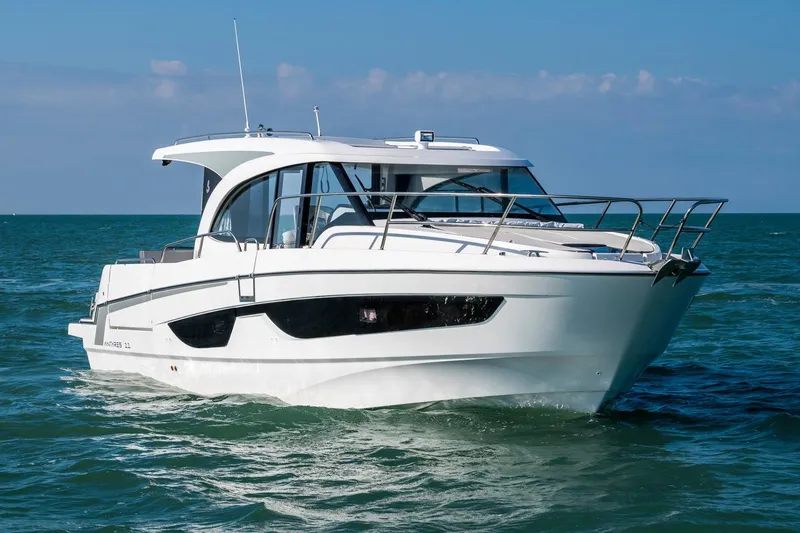 Slide: The Image of Manufacturer Provided Image: 2026 Beneteau Antares 11 Coupe cruising on open water under clear skies. - 3
