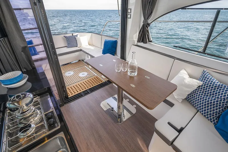 Slide: The Image of Manufacturer Provided Image: Interior of 2026 Beneteau Antares 11 Coupe with elegant seating and ocean view. - 9