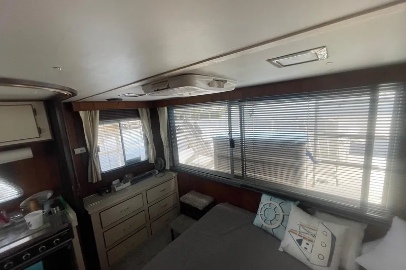 Slide: The Image of Interior of 1991 Gibson 37 Standard Houseboat with cozy furnishings and large windows. - 10