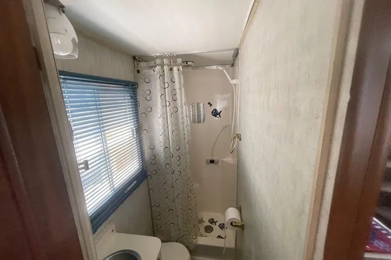 Slide: The Image of Bathroom interior of 1991 Gibson 37 Standard Houseboat with shower and window blinds. - 11