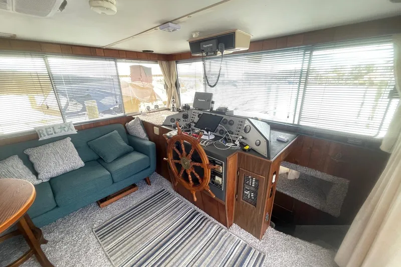 Slide: The Image of Interior of a 1991 Gibson 37 Standard Houseboat with helm, sofa, and nautical decor. - 13
