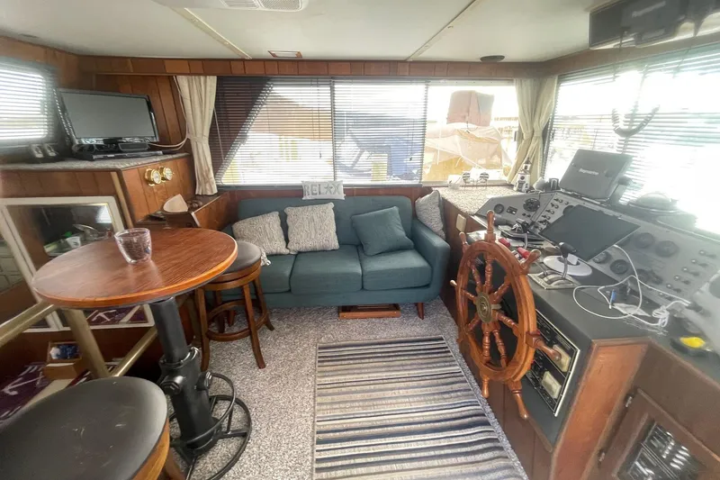 Slide: The Image of Interior of a 1991 Gibson 37 Standard Houseboat with cozy seating and navigation controls. - 14
