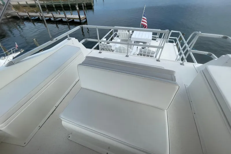 Slide: The Image of Upper deck of 1991 Gibson 37 Standard Houseboat with seating and American flag. - 28