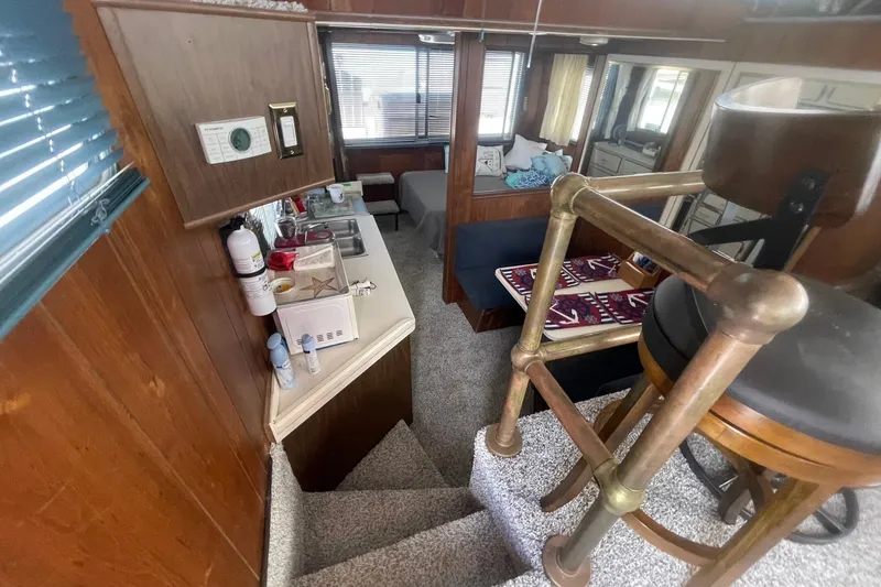 Slide: The Image of Interior of a 1991 Gibson 37 Standard Houseboat with kitchen and seating area. - 4