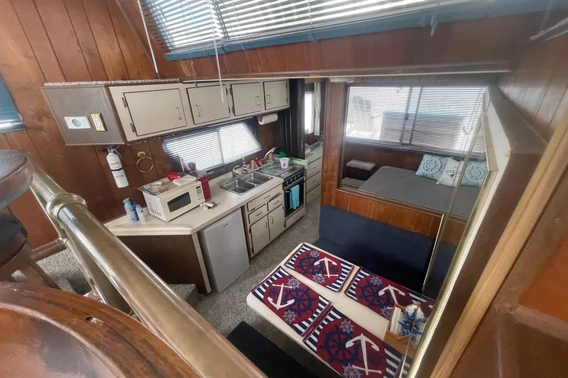 Slide: The Image of Interior of 1991 Gibson 37 Standard Houseboat with kitchen and cozy sleeping area. - 5