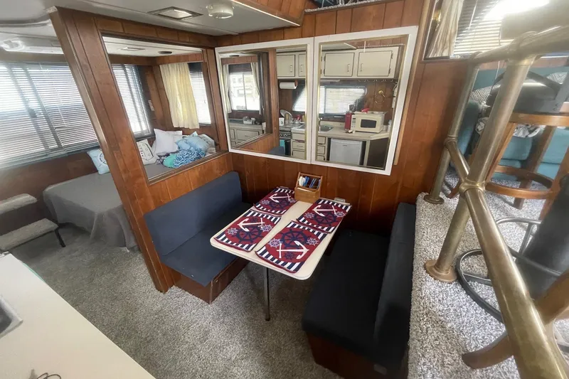 Slide: The Image of Interior of a 1991 Gibson 37 Standard Houseboat with cozy dining area and nautical decor. - 6
