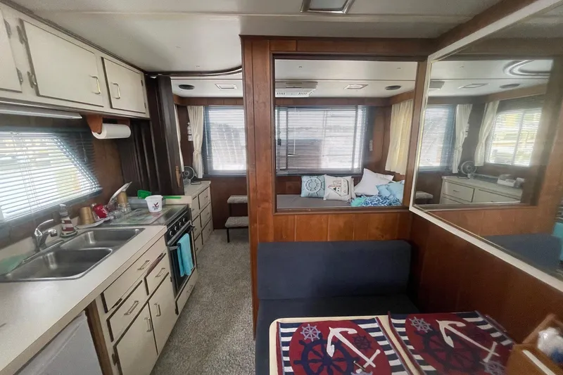 Slide: The Image of Interior of a 1991 Gibson 37 Standard Houseboat with kitchen and seating area. - 8