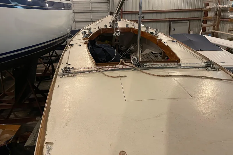 Slide: The Image of 1965 Chris Craft Shields sailboat in storage, showcasing deck and rigging details. - 6