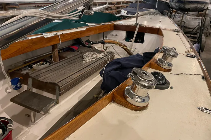 Slide: The Image of 1965 Chris Craft Shields sailboat interior with wooden bench and nautical equipment. - 7