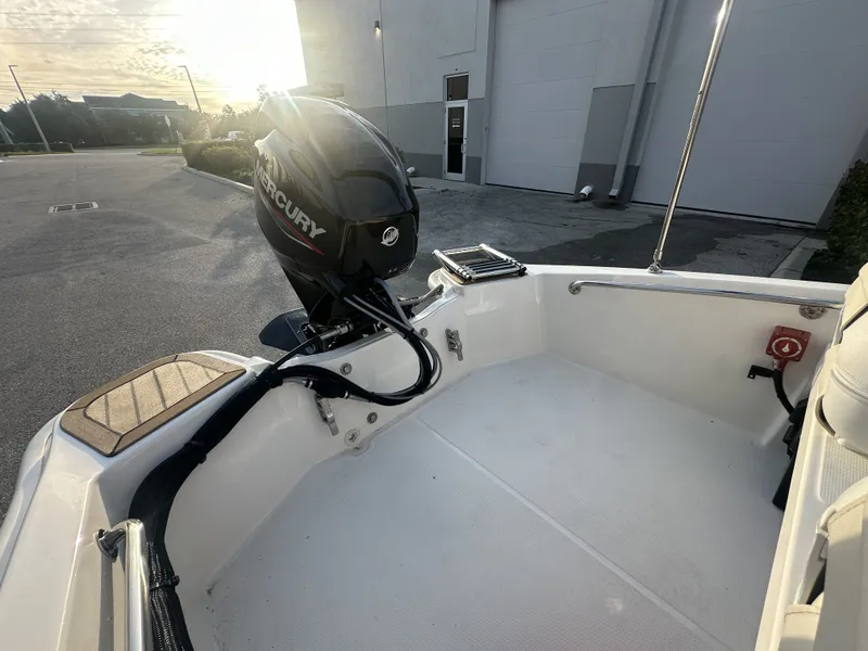 Slide: The Image of Boston Whaler 130 Super Sport 2025 with Mercury engine in sunlight. - 10