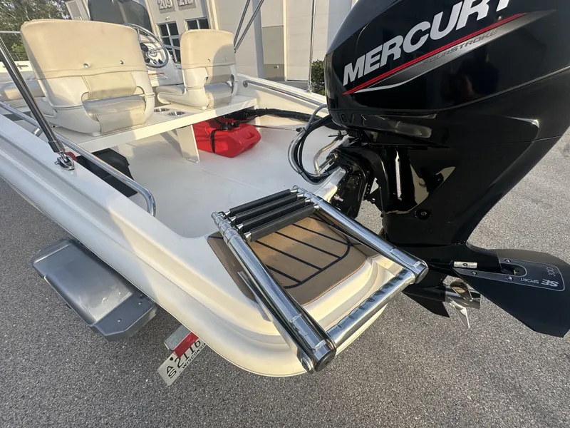 Slide: The Image of 2025 Boston Whaler 130 Super Sport with Mercury engine and swim ladder. - 11