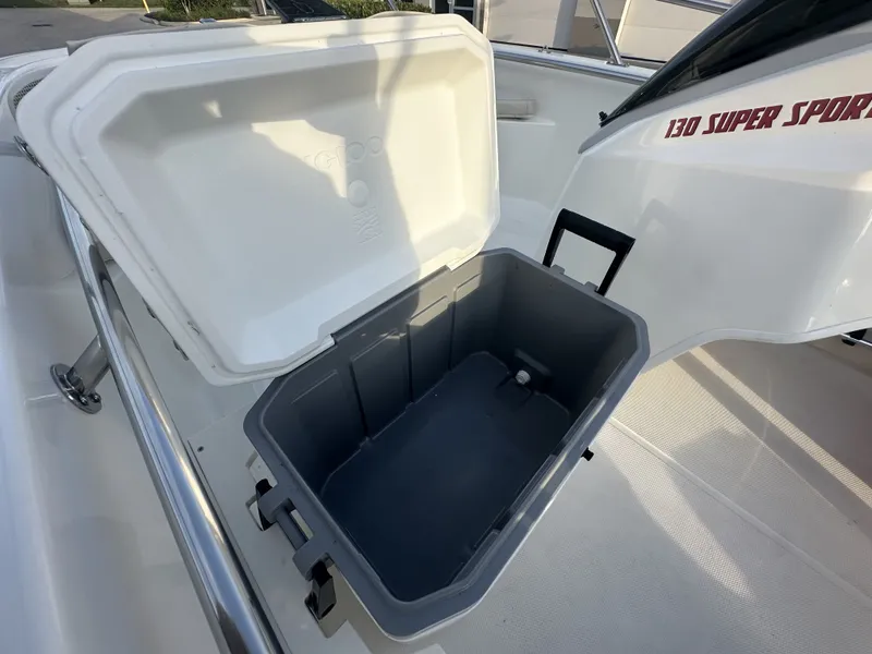 Slide: The Image of Boston Whaler 130 Super Sport 2025 with open cooler lid. - 12