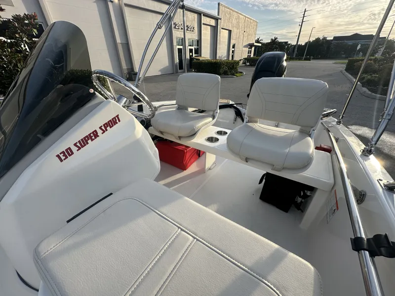 Slide: The Image of Interior of 2025 Boston Whaler 130 Super Sport with white seats. - 6