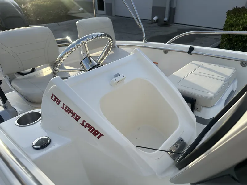 Slide: The Image of Interior of 2025 Boston Whaler 130 Super Sport with steering wheel and seat. - 9