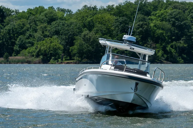 Slide: The Image of Nimbus Tender 9 2023 cruising on a lake with lush forest backdrop. - 22
