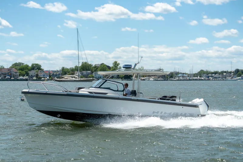 Slide: The Image of Nimbus Tender 9 boat 2023 cruising on water under sunny skies. - 25