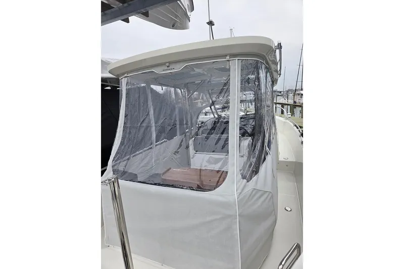 Slide: The Image of 2023 Nimbus T9 boat with clear protective enclosure at marina. - 28