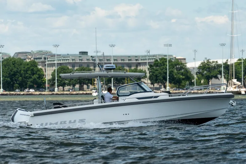 Slide: The Image of Nimbus Tender 9 boat 2023 cruising on water near cityscape. - 4