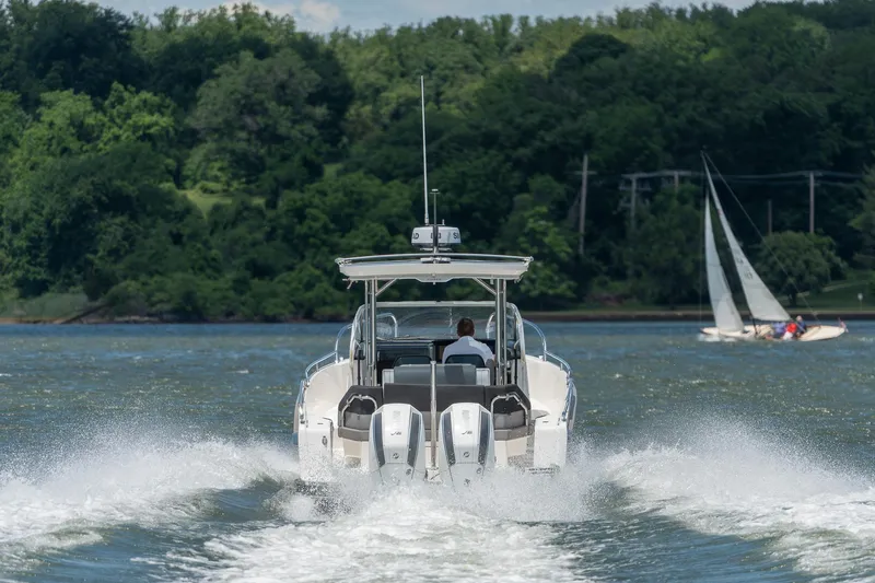 Slide: The Image of Nimbus Tender 9 2023 on a lake with sailboat in background. - 6