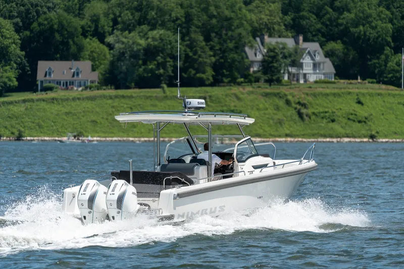 Slide: The Image of Nimbus Tender 9 boat 2023 on a lake with houses in the background. - 8