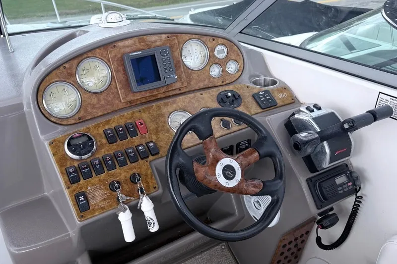 Slide: The Image of 2006 Rinker 300 Express Cruiser dashboard with gauges, steering wheel, and controls. - 21