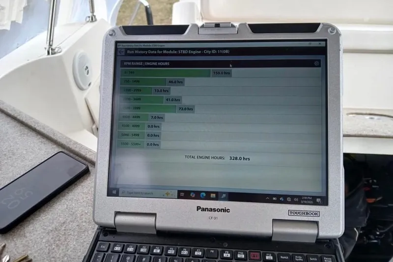 Slide: The Image of Panasonic Toughbook displaying engine hours data for 2006 Rinker 300 Express Cruiser. - 23