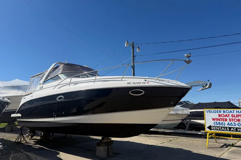 Slide: The Image of 2006 Rinker 300 Express Cruiser on display at a boat storage facility. - 4