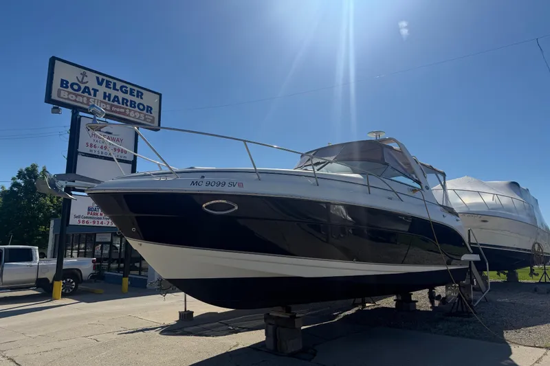 Slide: The Image of 2006 Rinker 300 Express Cruiser at Velger Boat Harbor under clear blue sky. - 5