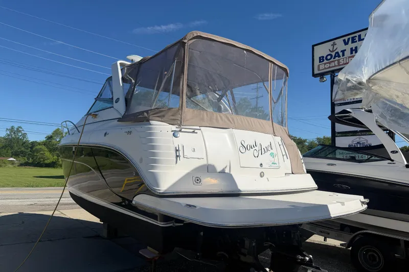 Slide: The Image of 2006 Rinker 300 Express Cruiser boat displayed outdoors on a sunny day. - 6