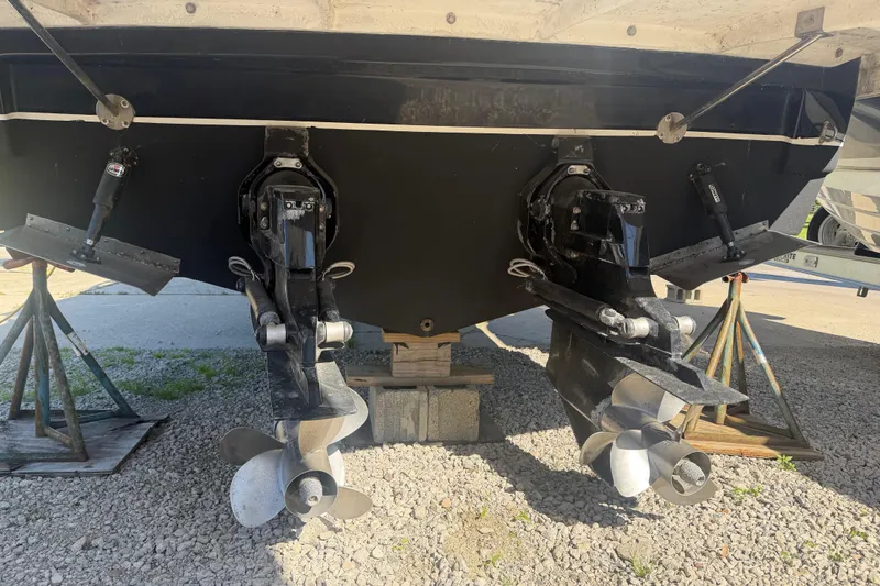 Slide: The Image of Rear view of a 2006 Rinker 300 Express Cruiser showing dual propellers and outdrives. - 7