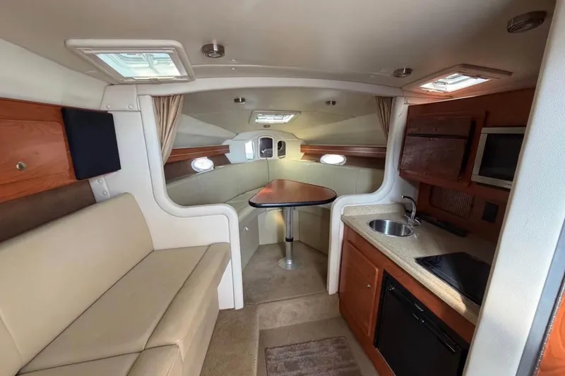 Slide: The Image of Interior of 2006 Rinker 300 Express Cruiser with kitchenette and seating area. - 8