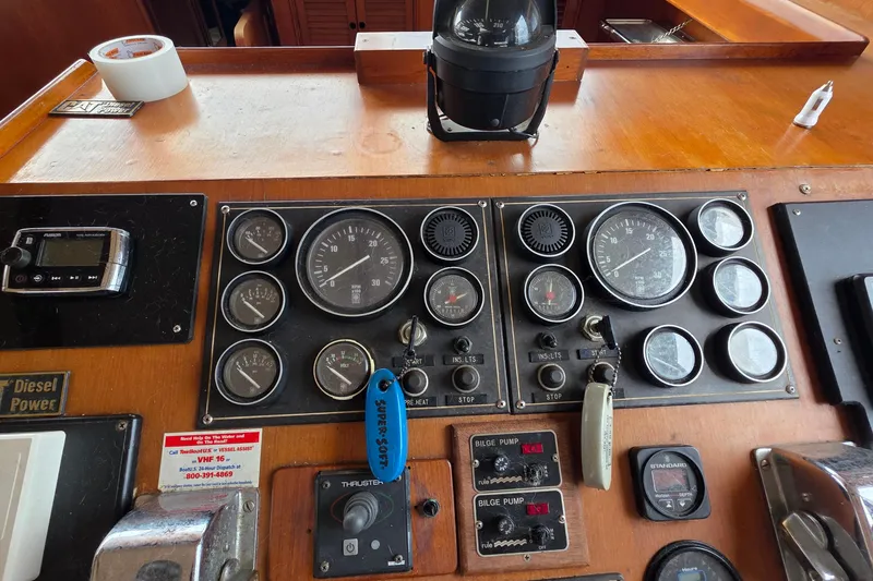 Slide: The Image of 1991 Marine Trader Trawler dashboard with gauges, controls, and navigation instruments. - 15