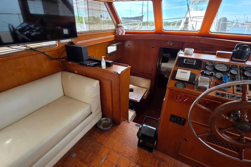 Slide: The Image of Interior of a 1991 Marine Trader Trawler with helm, seating, and navigation equipment. - 16