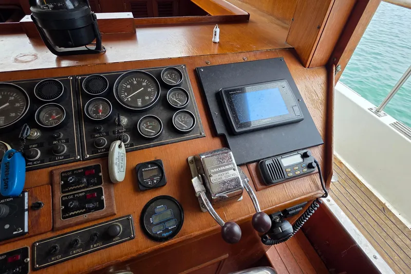 Slide: The Image of 1991 Marine Trader Trawler dashboard with gauges, controls, and navigation equipment. - 19